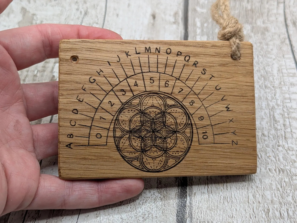 Oak wood pocket pendulum with geometric laser print. Travel sized.