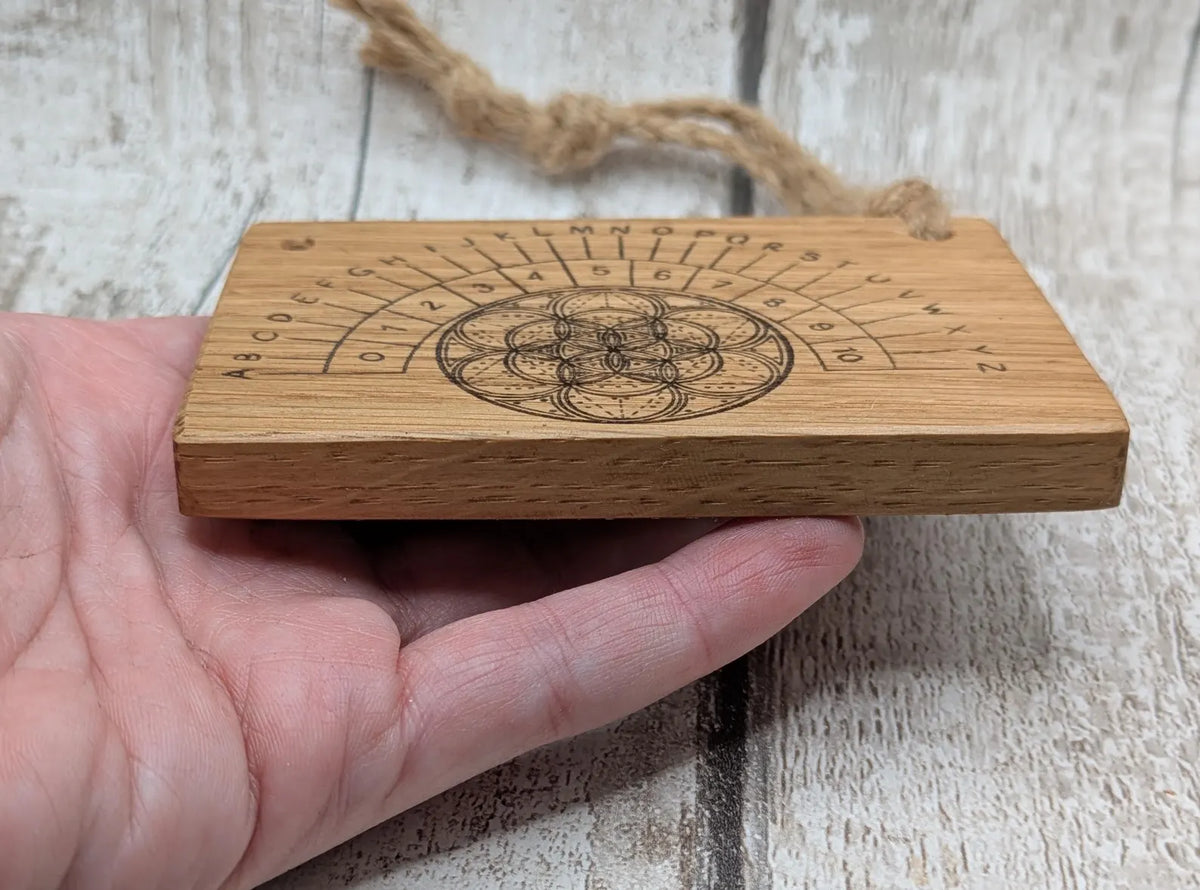 Oak wood pocket pendulum with geometric laser print. Travel sized.