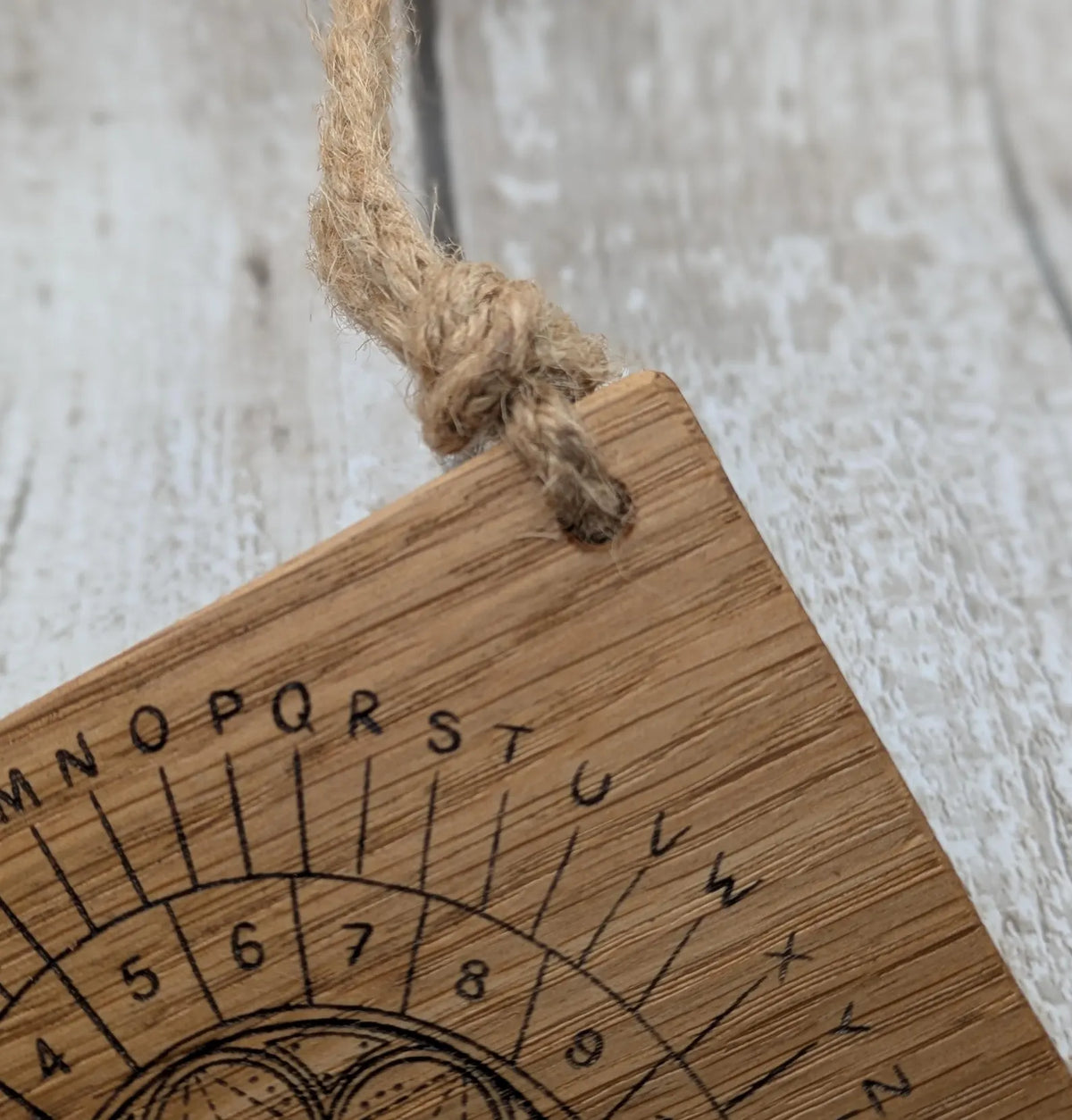 Oak wood pocket pendulum with geometric laser print. Travel sized.