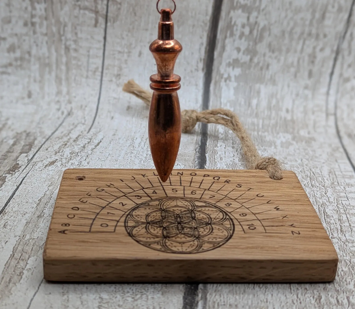 Oak wood pocket pendulum with geometric laser print. Travel sized.