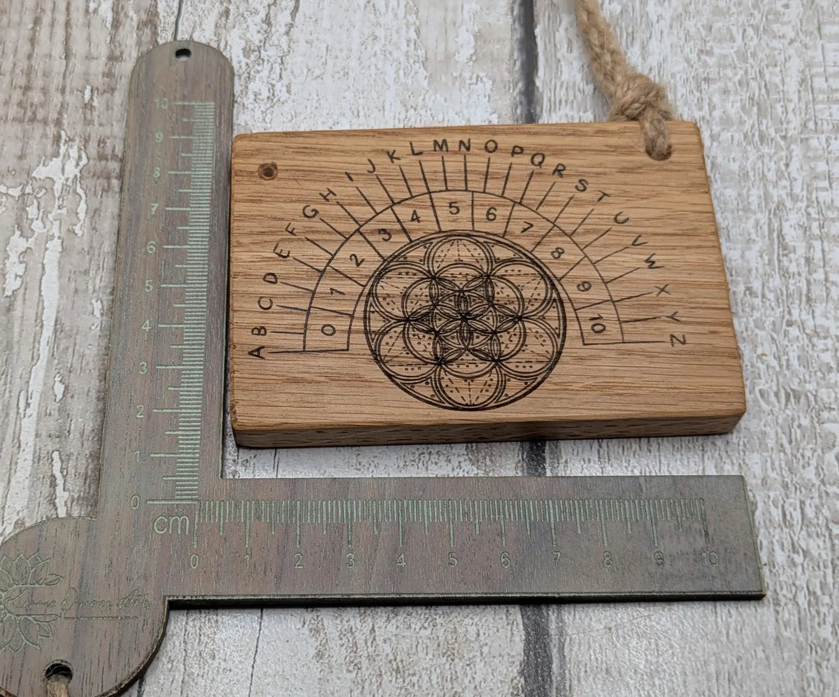 Oak wood pocket pendulum with geometric laser print. Travel sized.