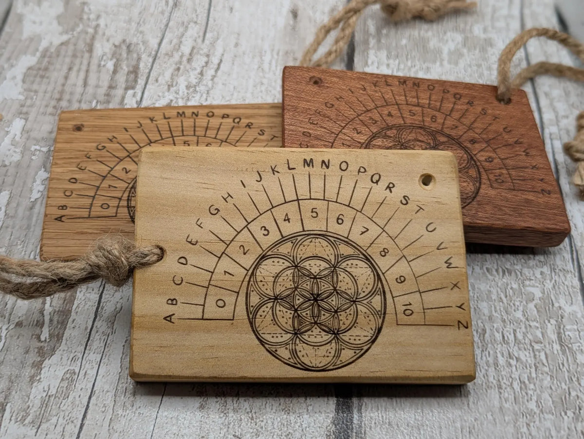 Sepele mahogany pendulum dowsing board with geometric print.