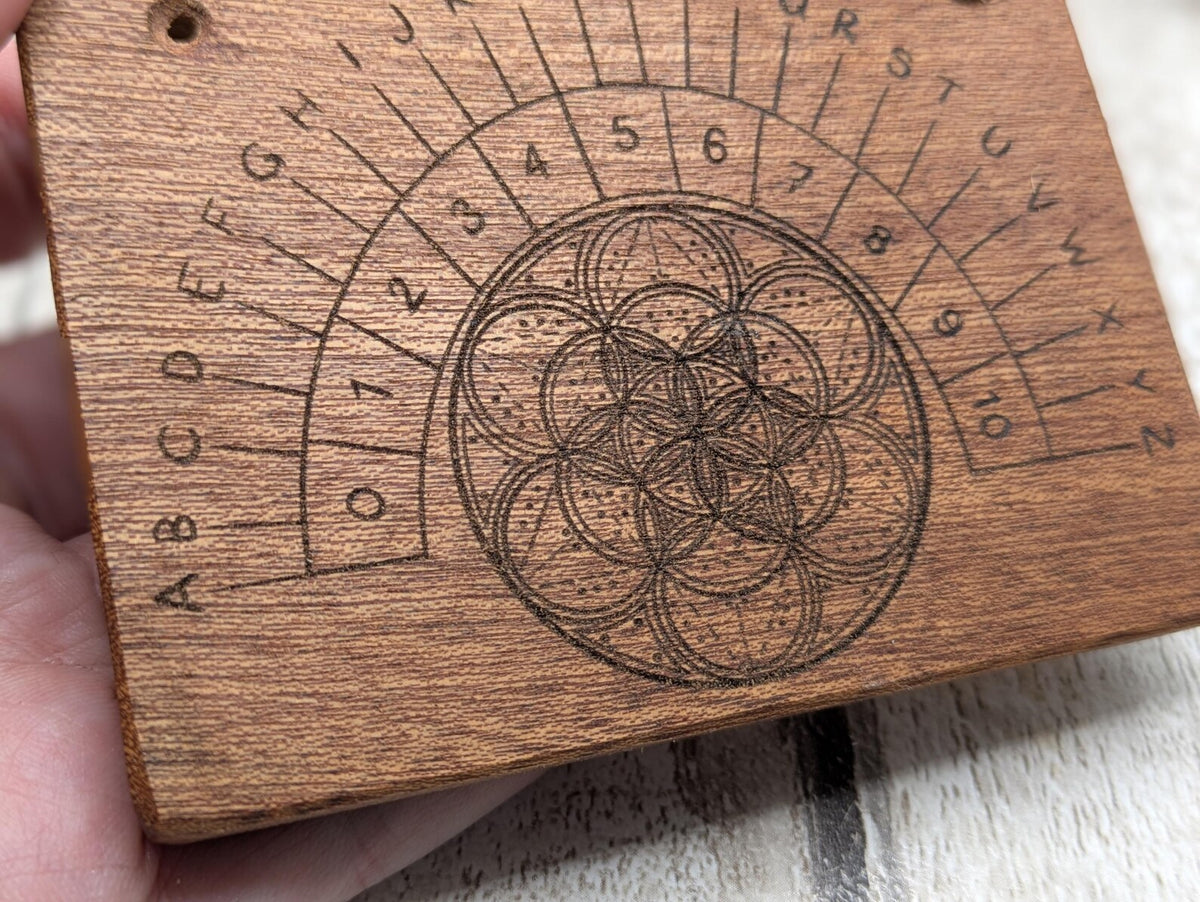 Sepele mahogany pendulum dowsing board with geometric print.