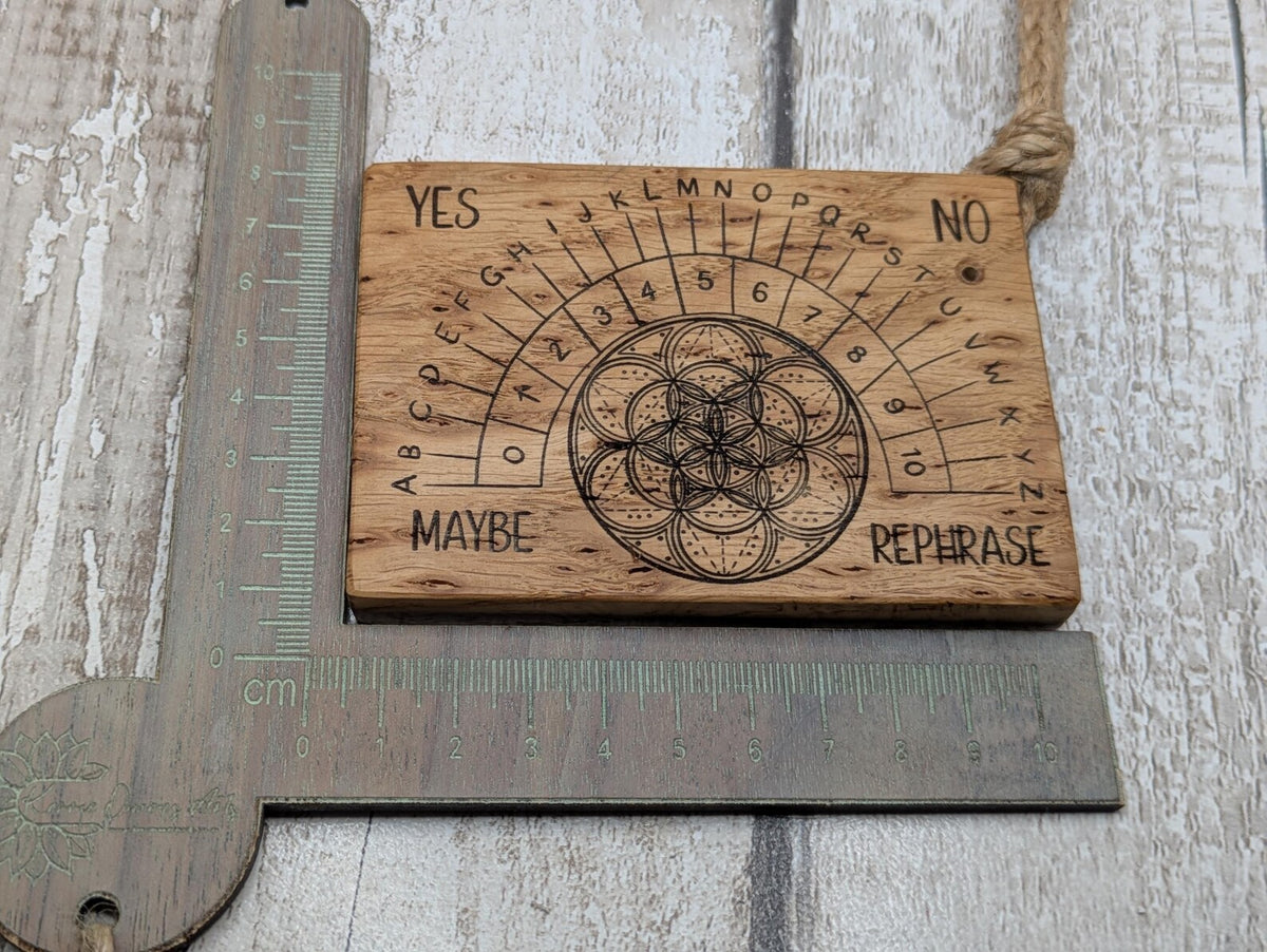 Iroko wood pocket pendulum board with geometric laser print design.