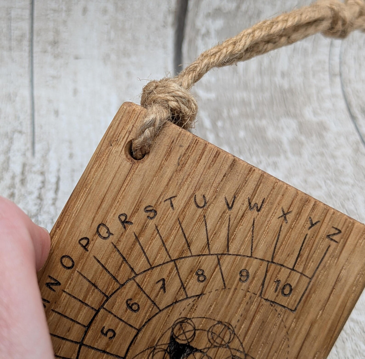 Oak wood pendulum board with Celtic geometric laser print design.