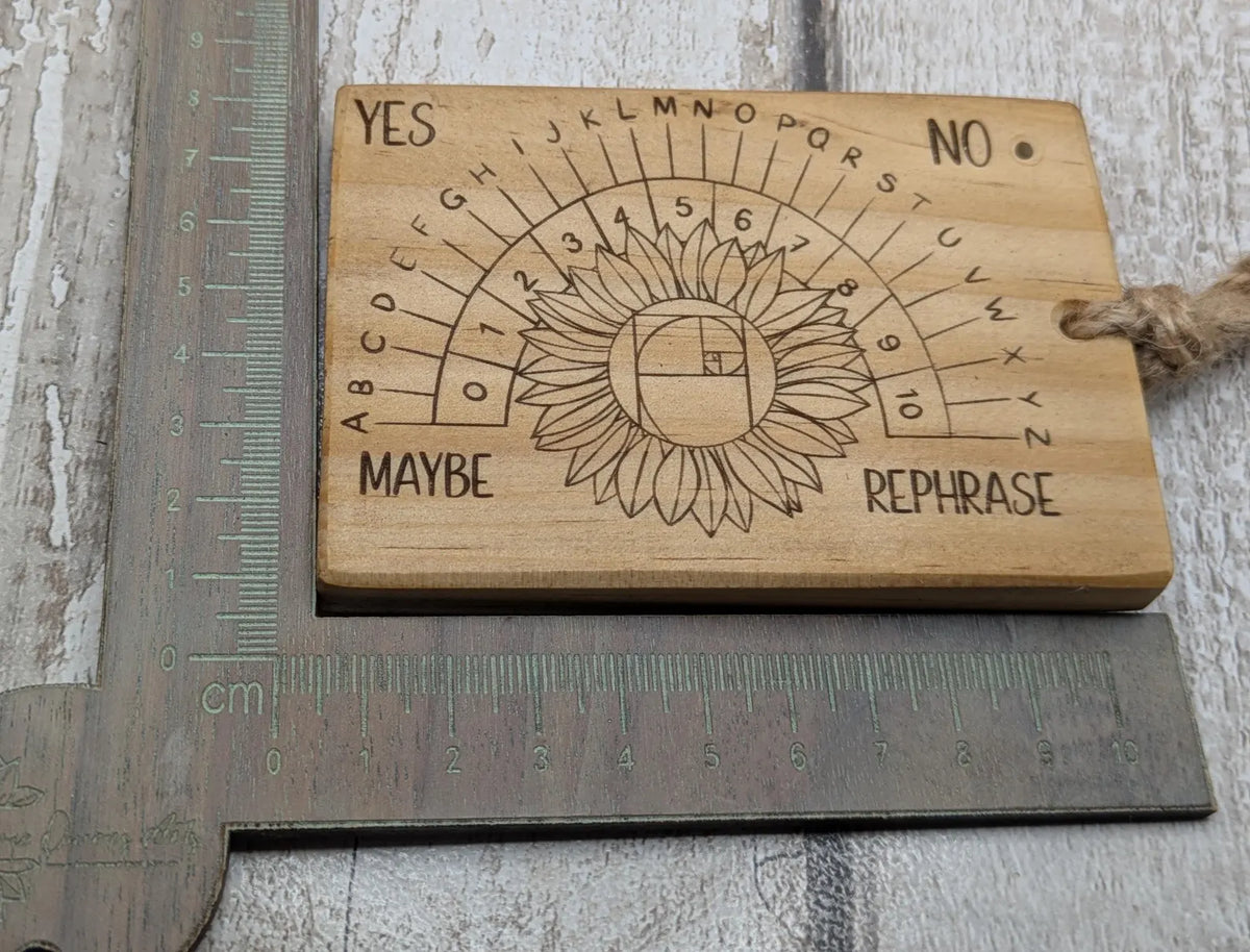 Tulip wood pendulum dowsing board with sunflower laser design.