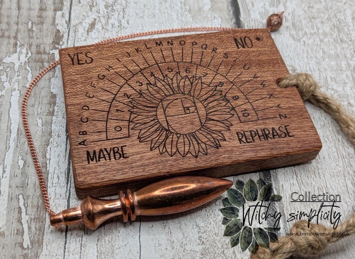 Sepele mahogany pendulum dowsing board with sunflower laser design.
