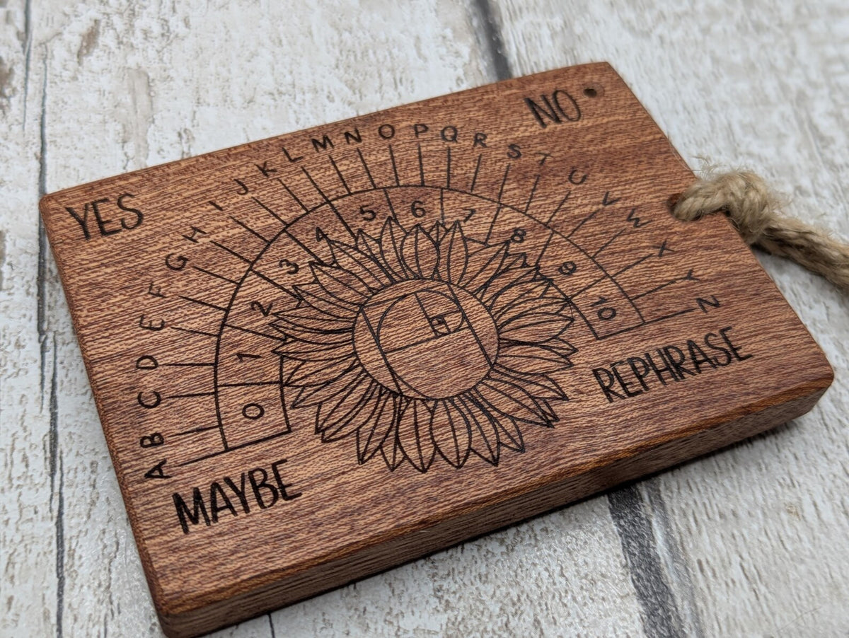 Sepele mahogany pendulum dowsing board with sunflower laser design.