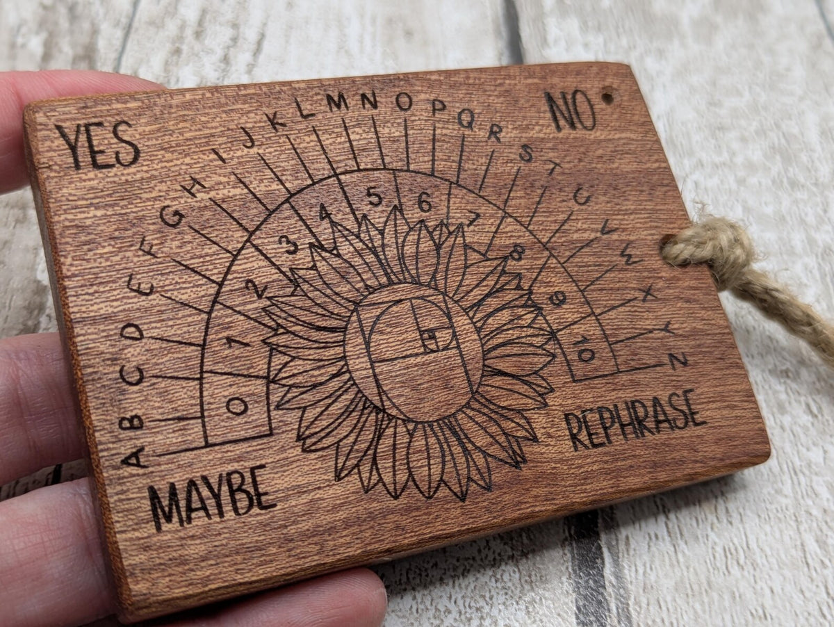 Sepele mahogany pendulum dowsing board with sunflower laser design.