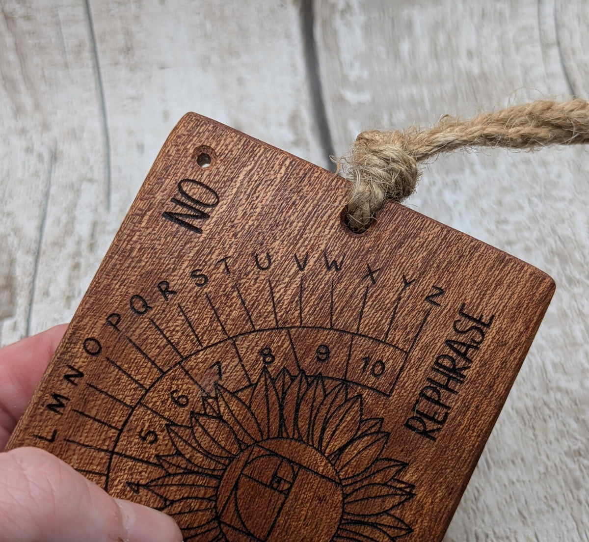 Sepele mahogany pendulum dowsing board with sunflower laser design.