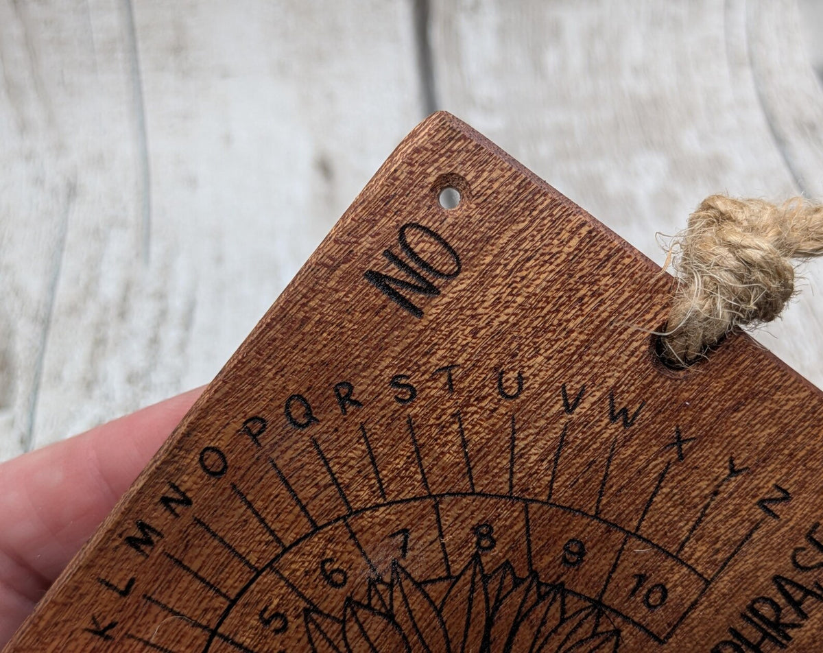 Sepele mahogany pendulum dowsing board with sunflower laser design.