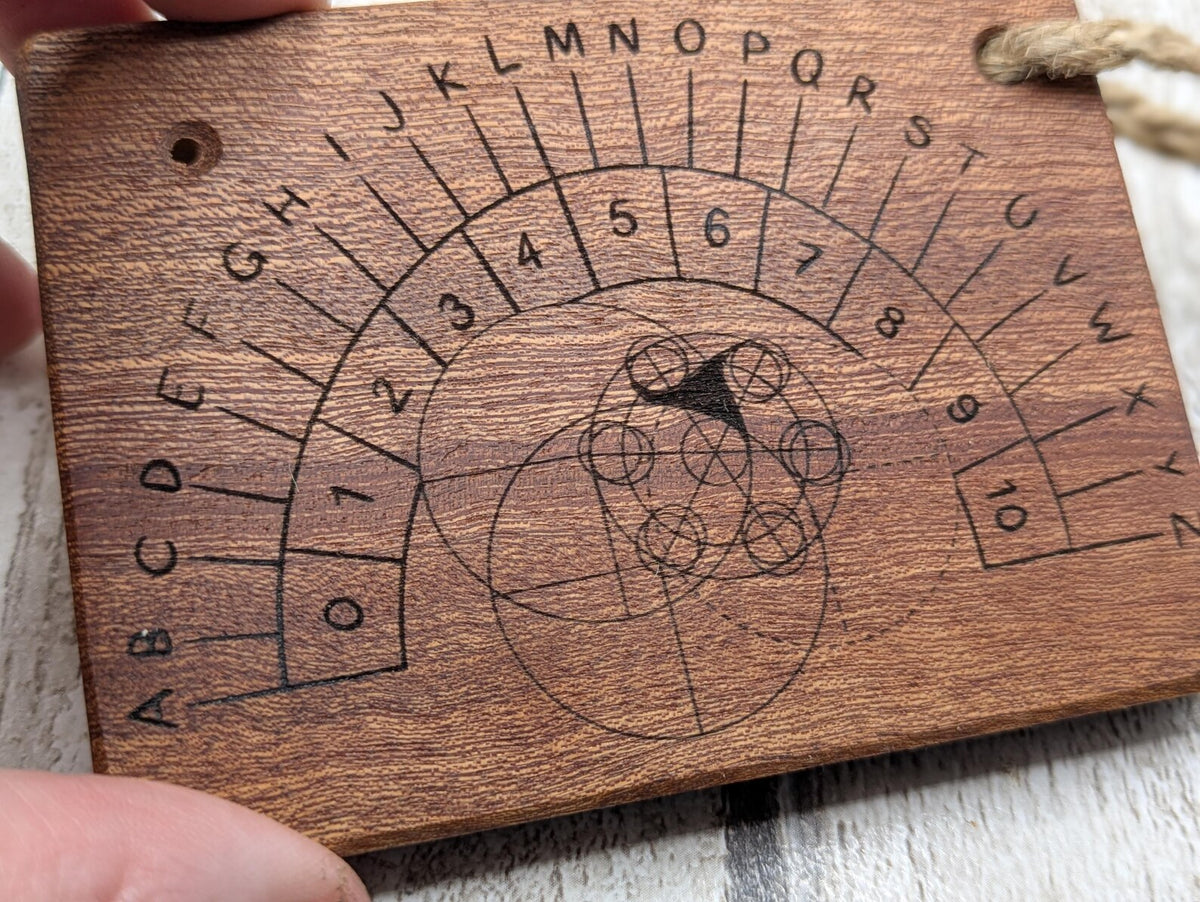 Sepele mahogany pendulum dowsing board with Celtic geometric design.