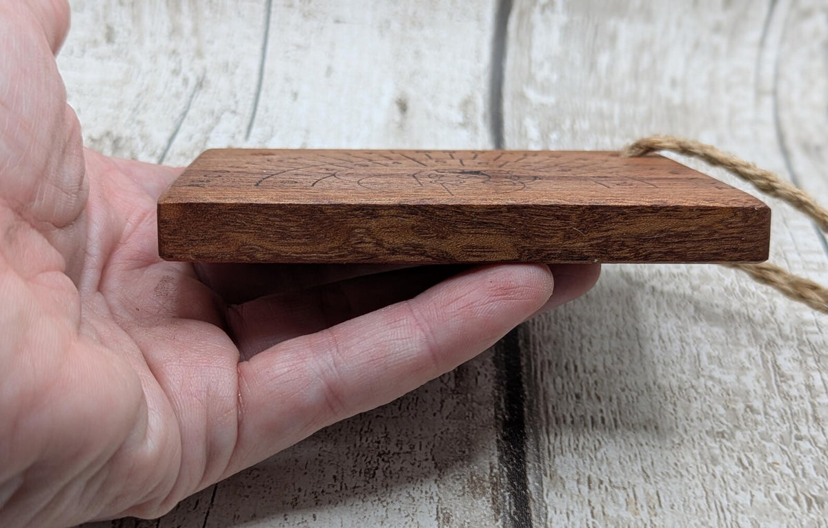 Sepele mahogany pendulum dowsing board with Celtic geometric design.