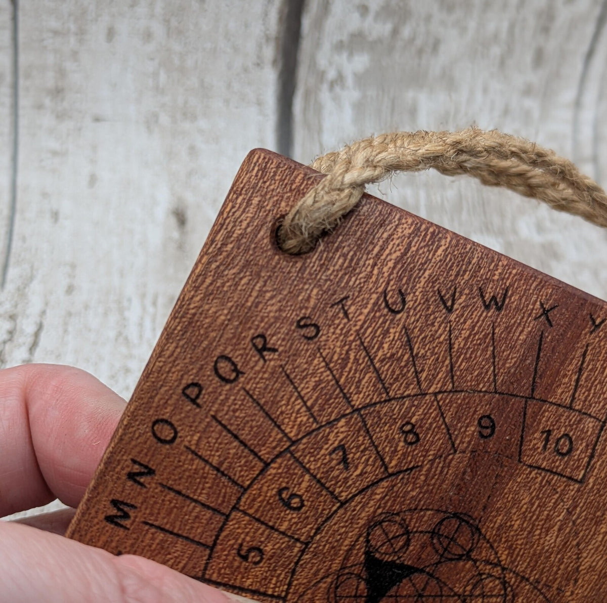 Sepele mahogany pendulum dowsing board with Celtic geometric design.