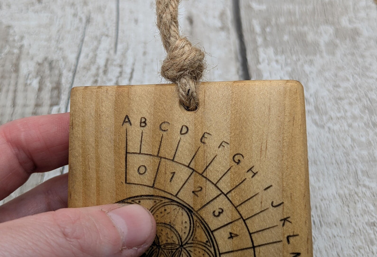 Tulip wood pendulum board with geometric laser print.