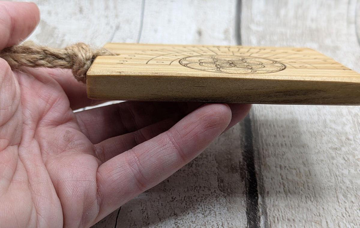 Tulip wood pendulum board with geometric laser print.