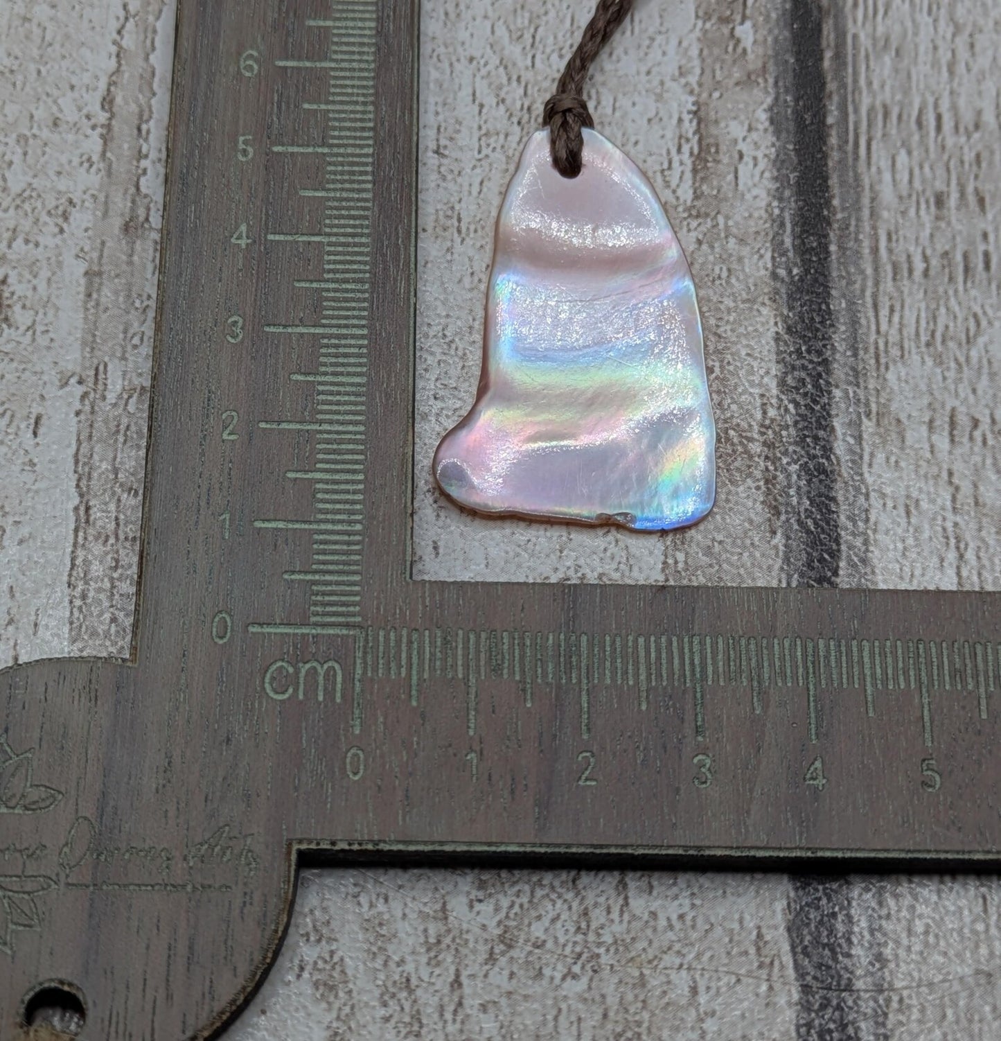 Pink freshwater mussel shell tumbled pendant.