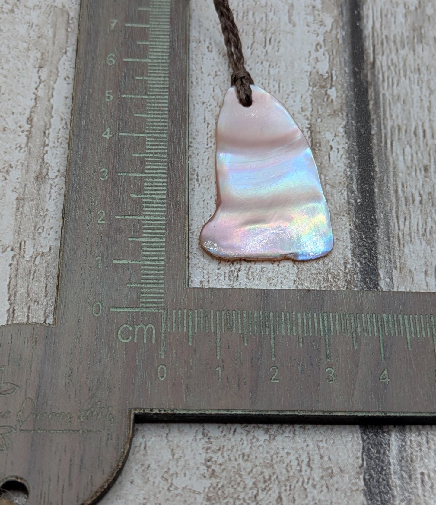 Pink freshwater mussel shell tumbled pendant.