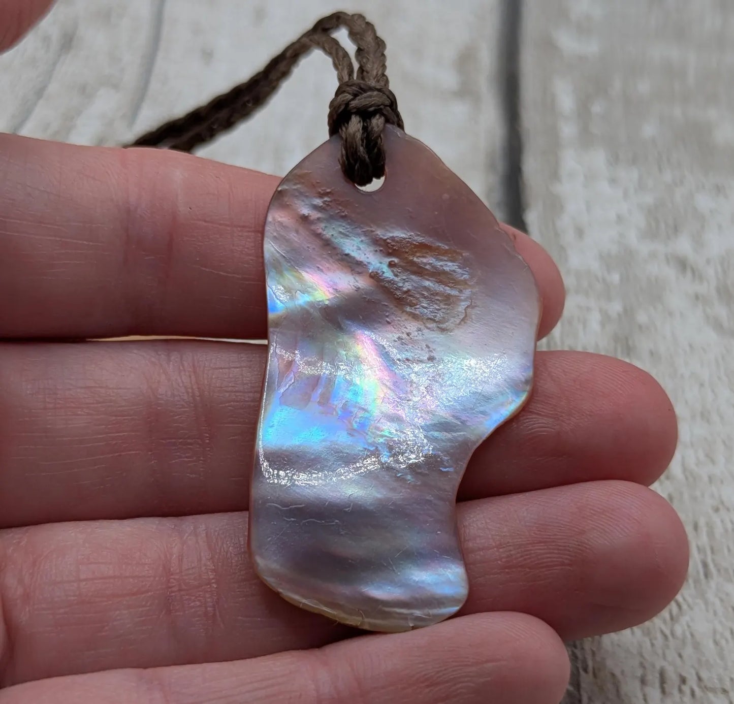 Pink freshwater mussel shell tumbled pendant.