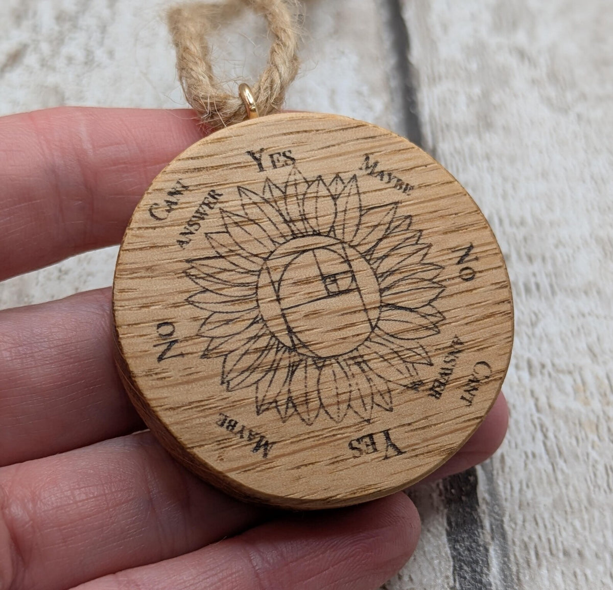 Oak wood mini pocket pendulum board with sunflower design.