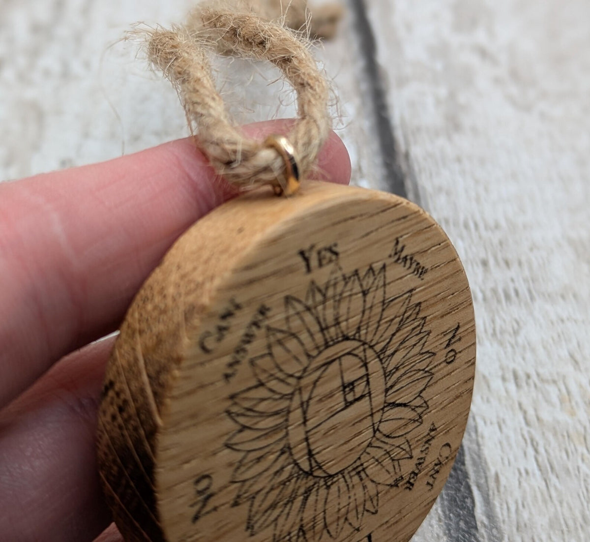 Oak wood mini pocket pendulum board with sunflower design.