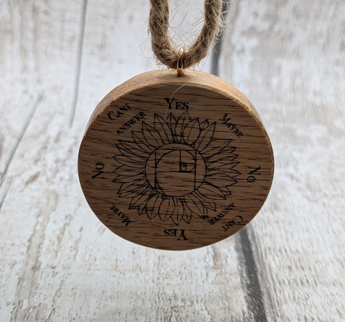 Oak wood mini pocket pendulum board with sunflower design.