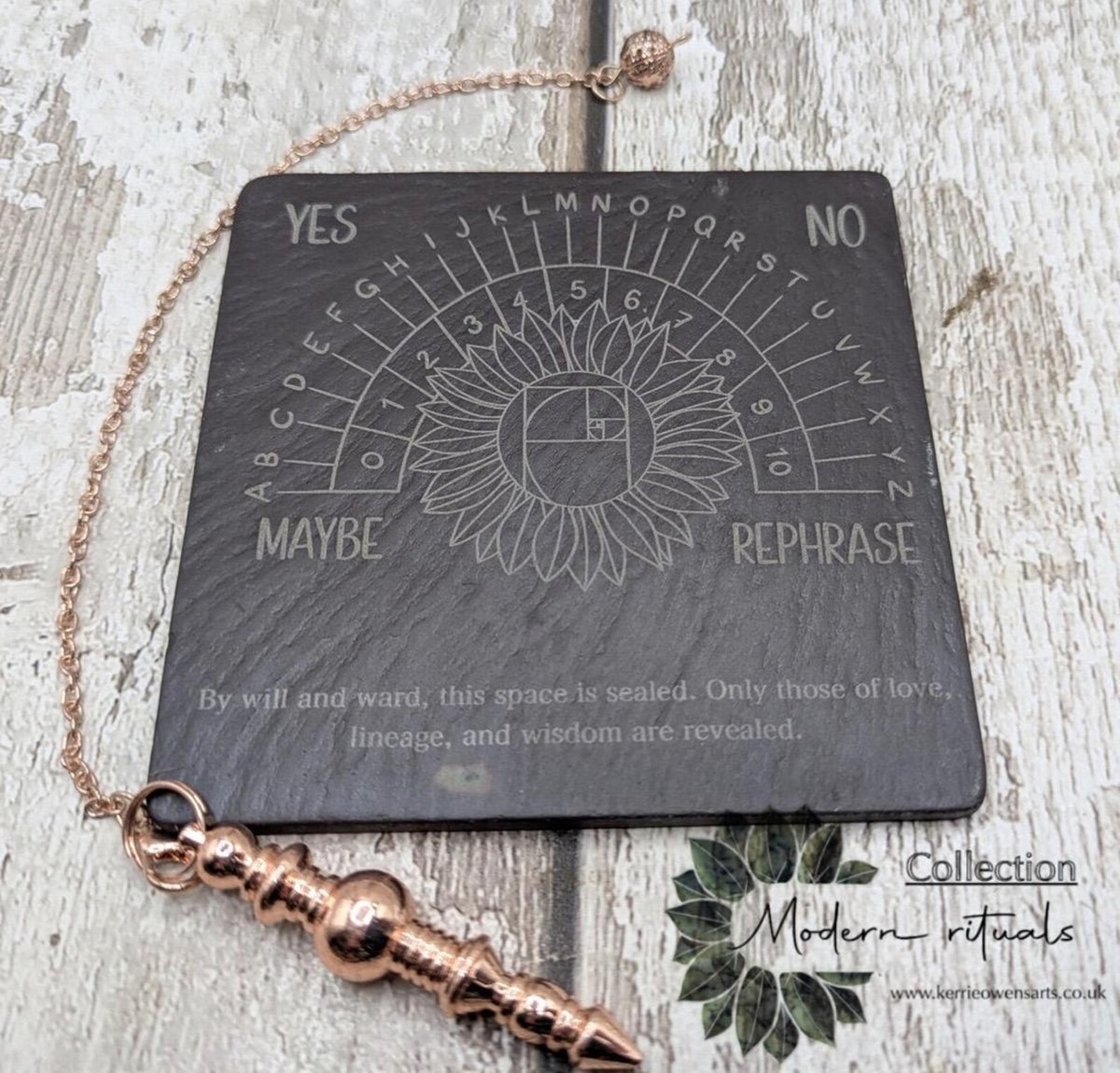 Welsh slate pendulum dowsing board with sunflower design.