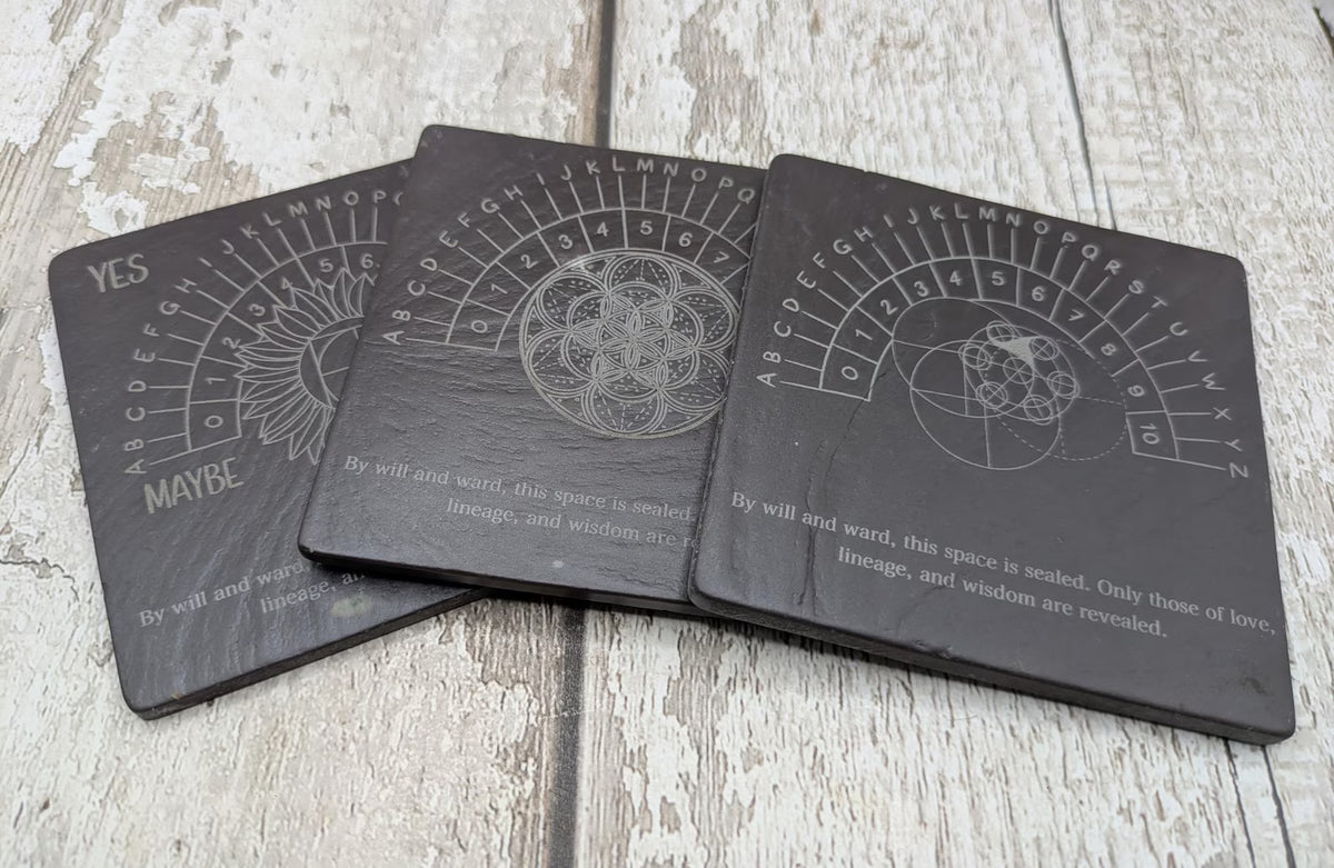 Welsh slate pendulum dowsing board with sunflower design.