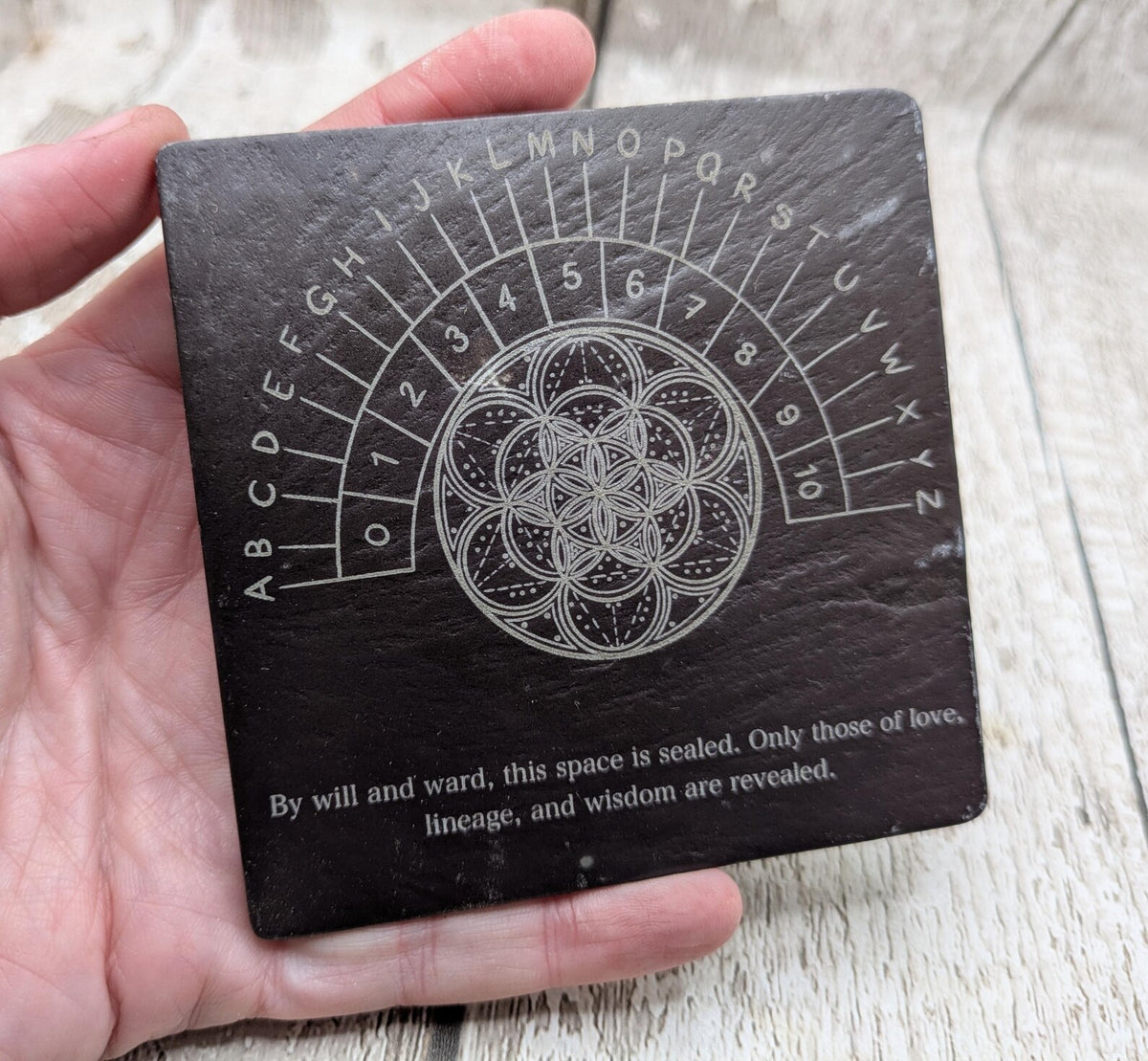 Welsh slate pendulum dowsing board with geometric print.