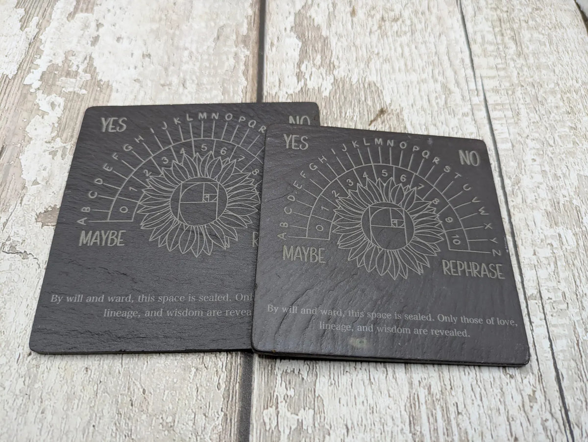 Welsh slate pendulum dowsing board with sunflower design.