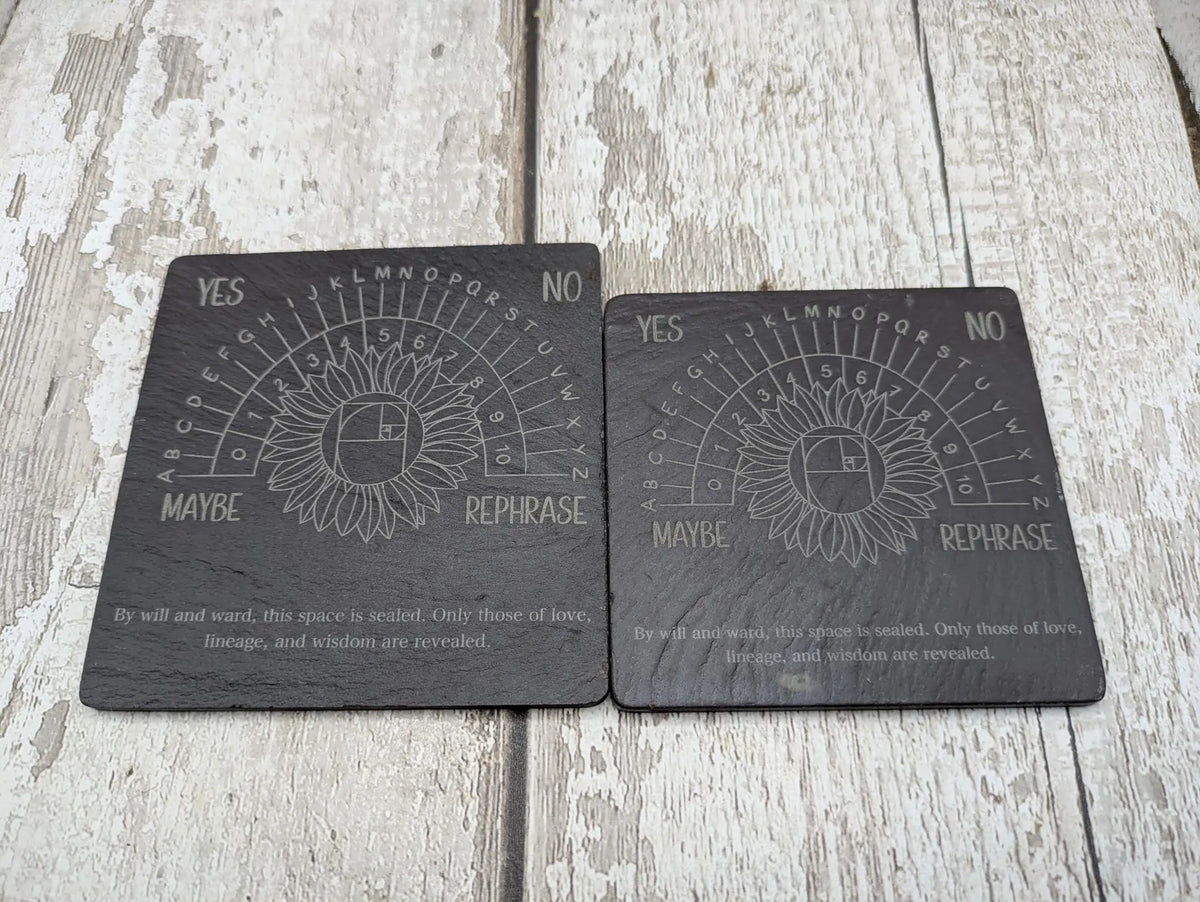 Welsh slate pendulum dowsing board with sunflower design.
