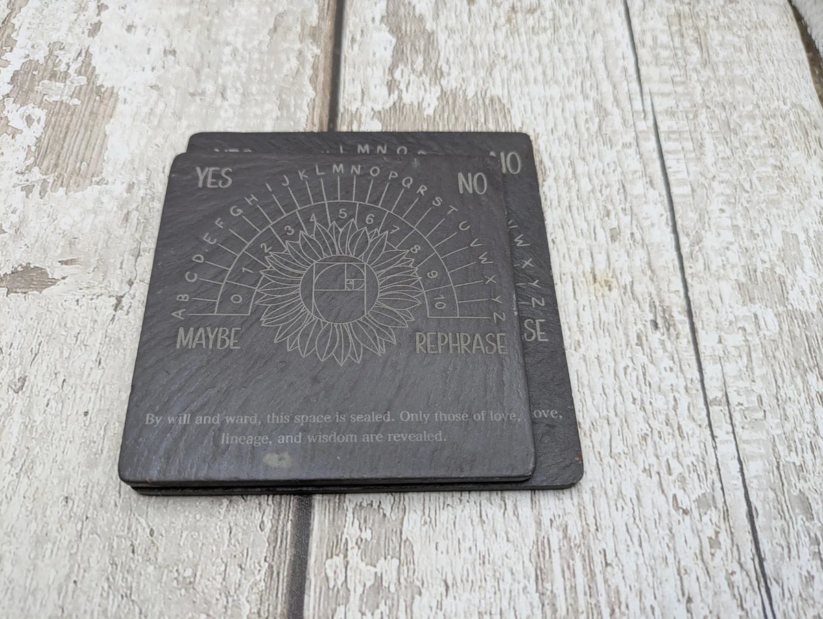 Welsh slate pendulum dowsing board with sunflower design.