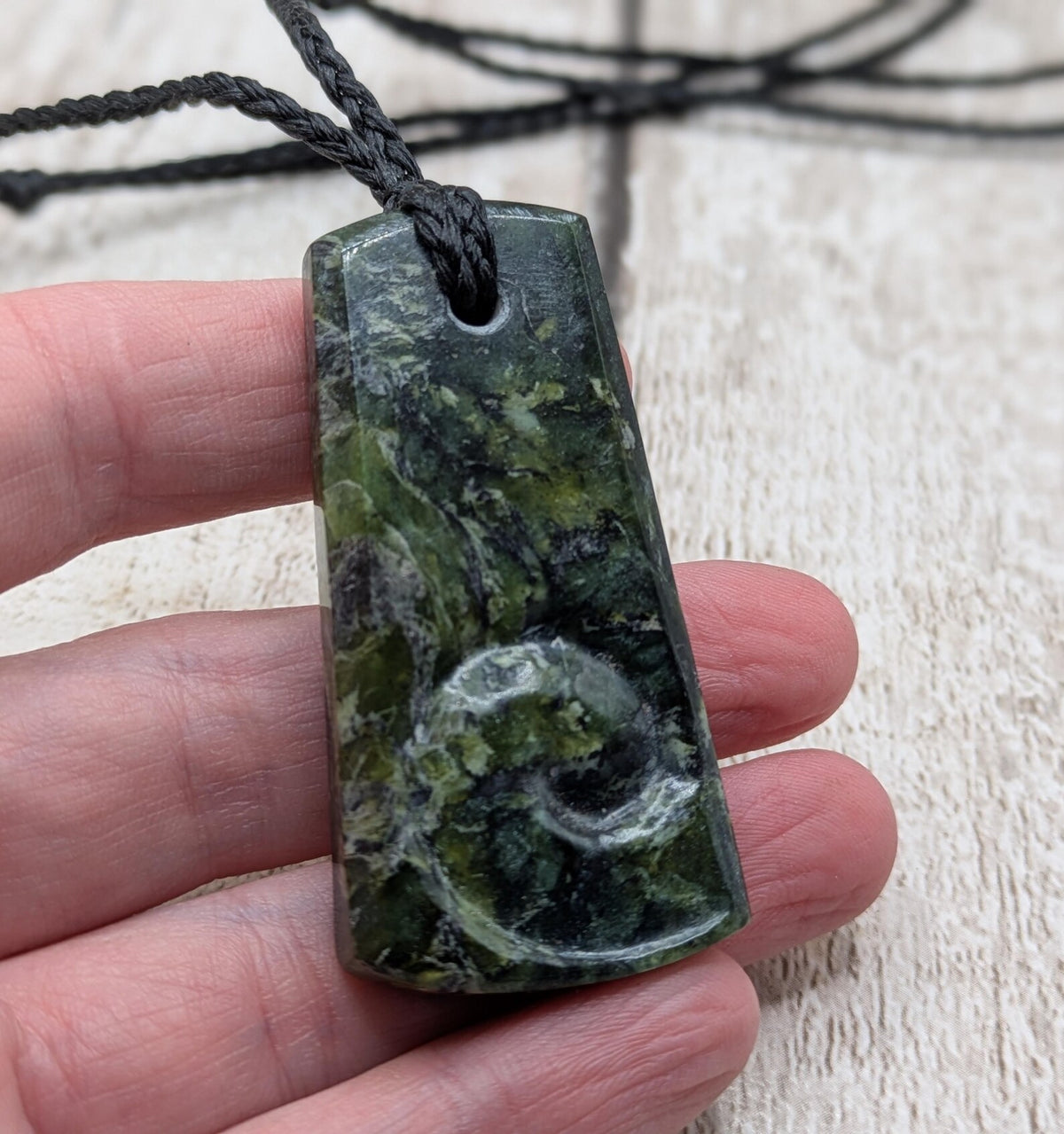 New Zealand Haast pass Douglas creek serpentine pounamu pendant with koru design.