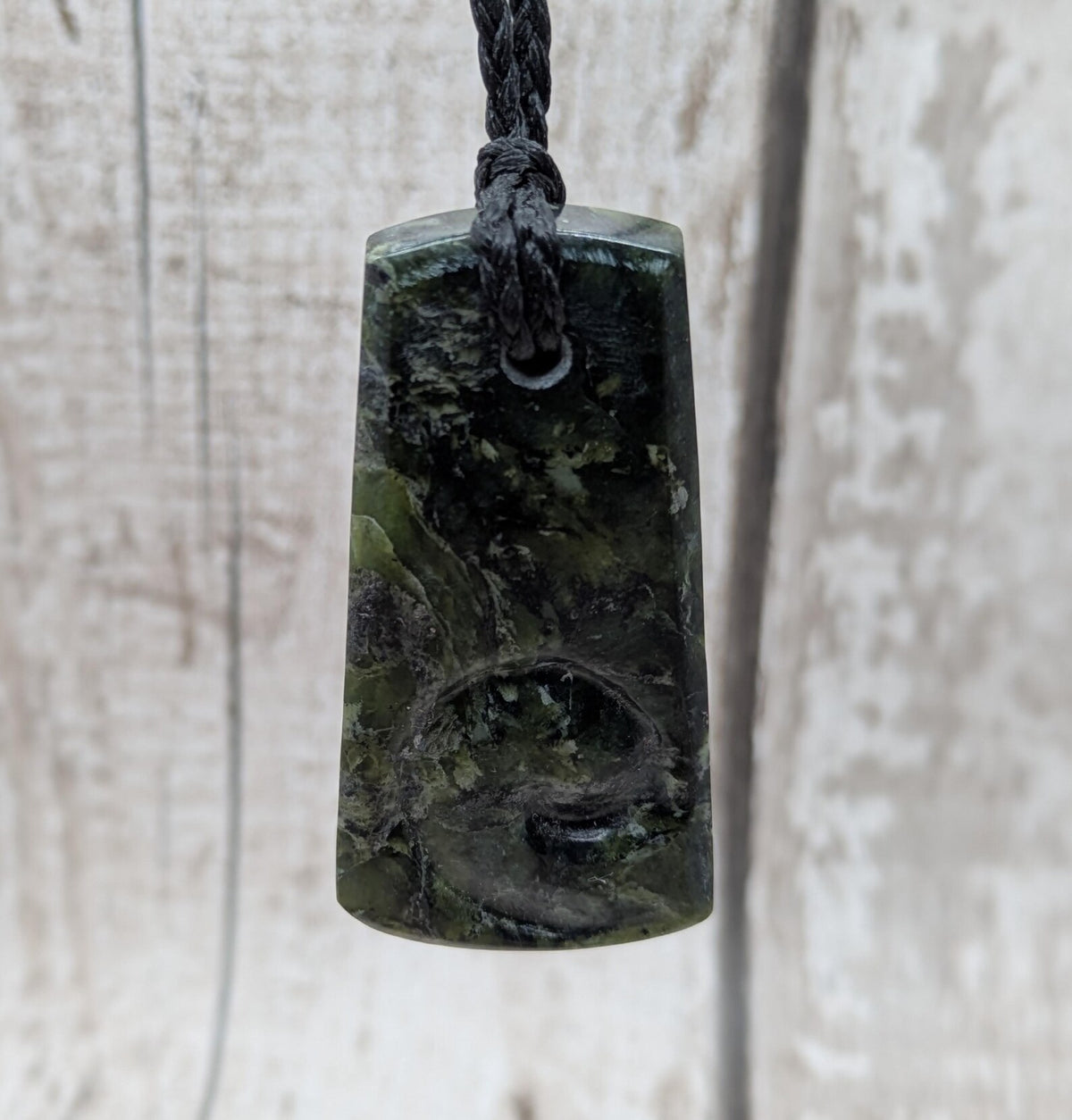 New Zealand Haast pass Douglas creek serpentine pounamu pendant with koru design.