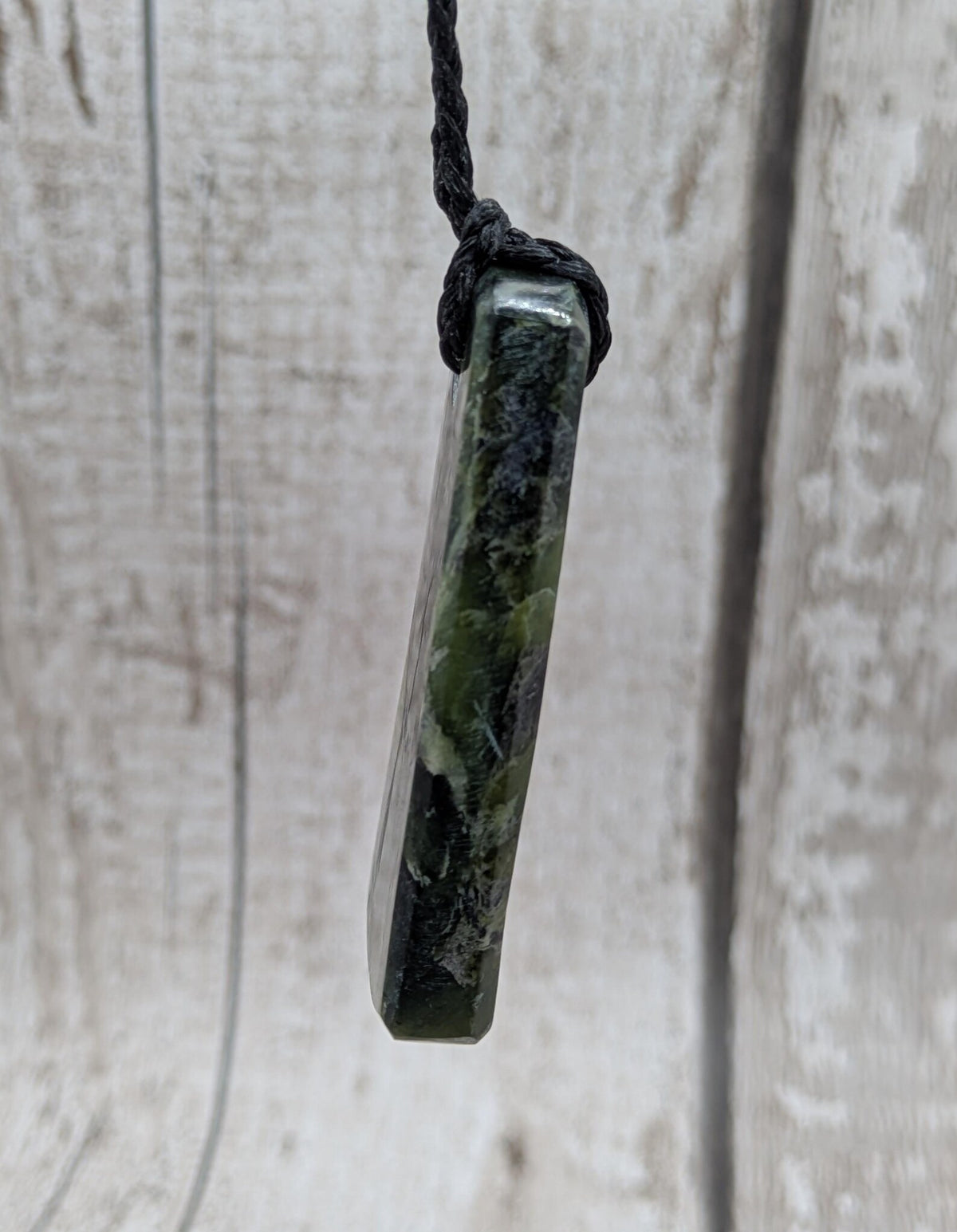 New Zealand Haast pass Douglas creek serpentine pounamu pendant with koru design.