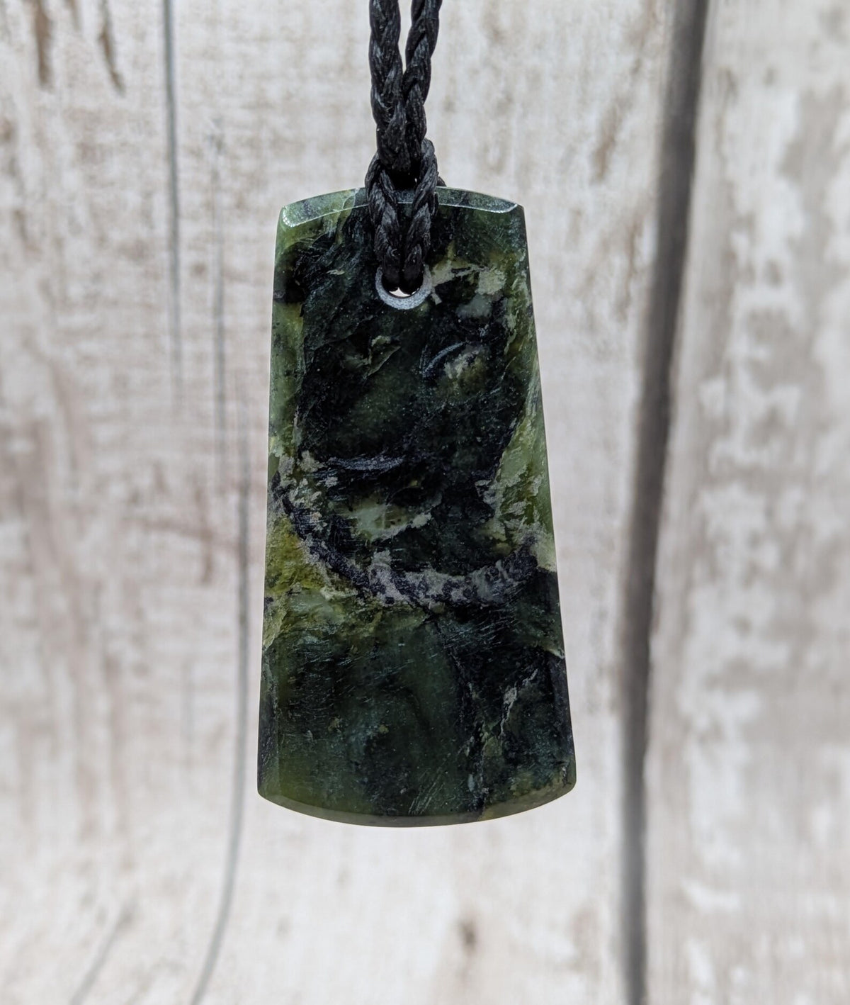 New Zealand Haast pass Douglas creek serpentine pounamu pendant with koru design.