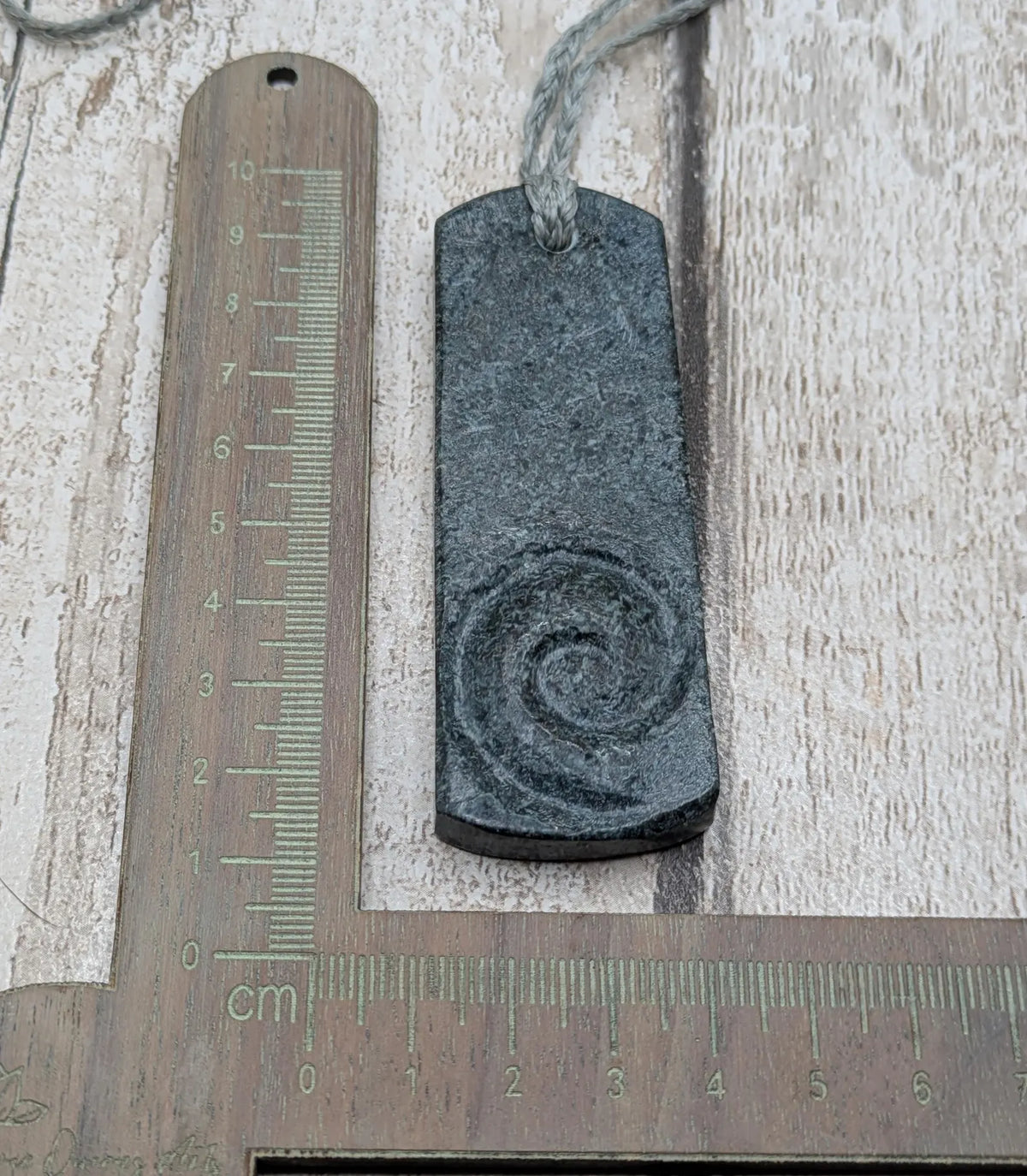 Statement preselli bluestone koru spiral pendant.