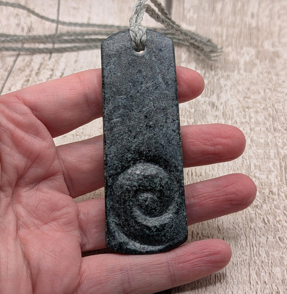 Statement preselli bluestone koru spiral pendant.