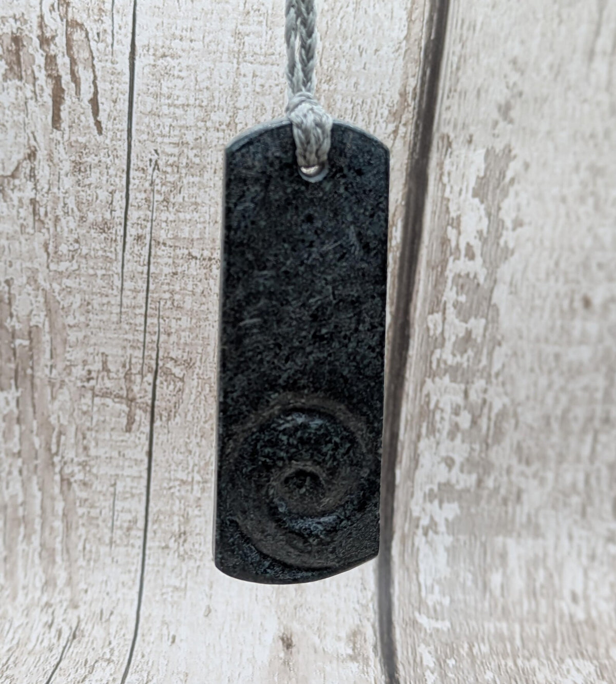 Statement preselli bluestone koru spiral pendant.