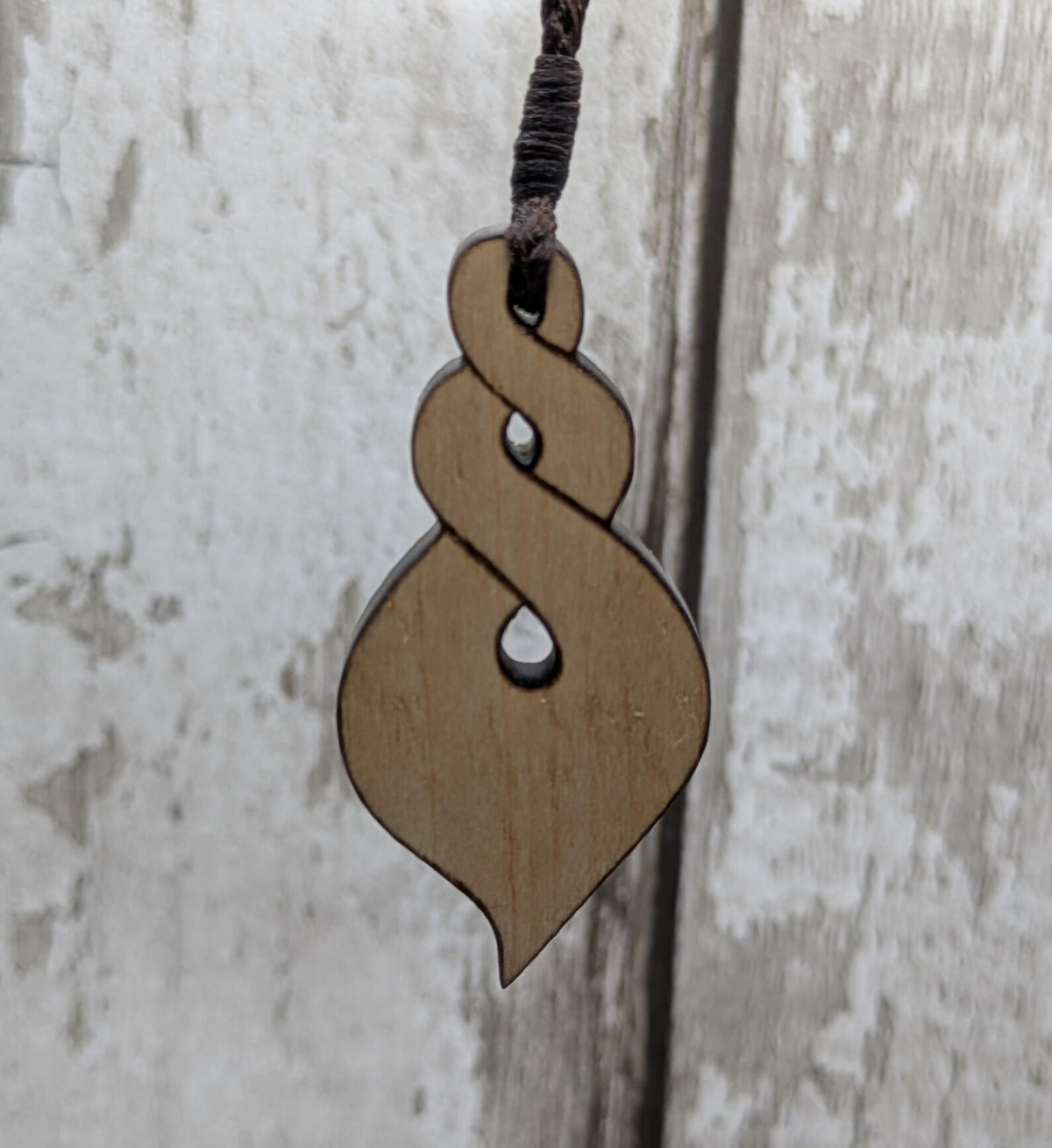 Lime wood, laser printed and cut pikorua pendant.