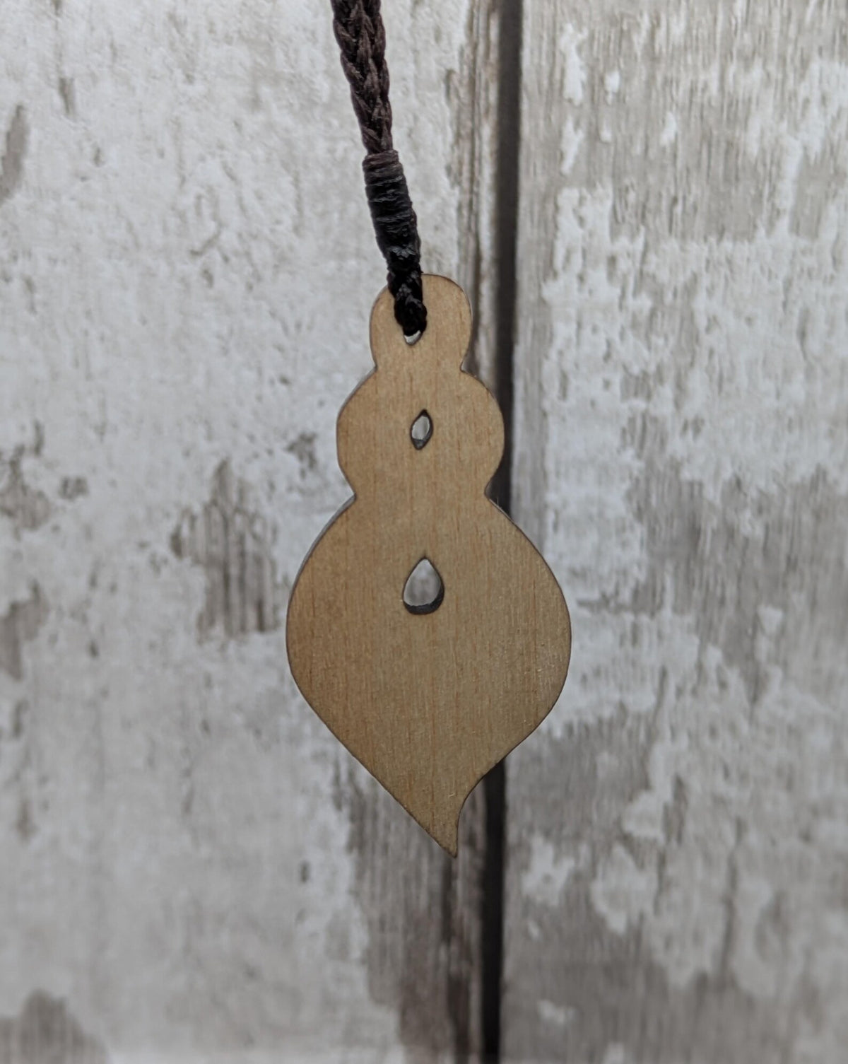 Lime wood, laser printed and cut pikorua pendant.