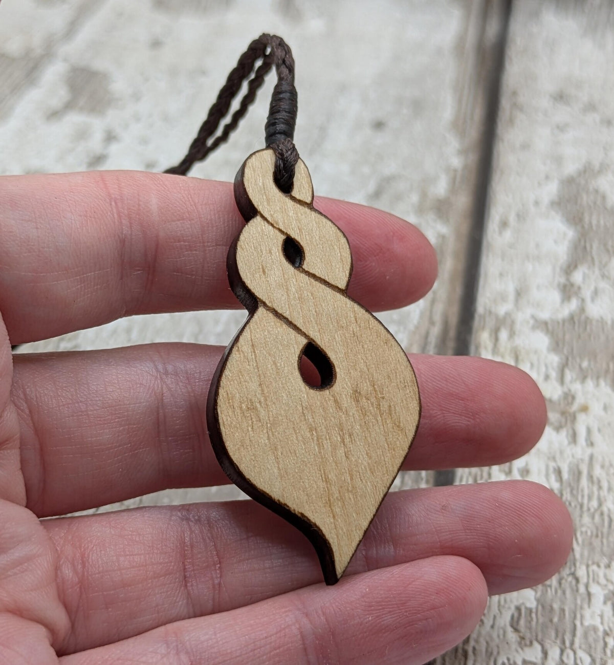 Lime wood, laser printed and cut pikorua pendant.