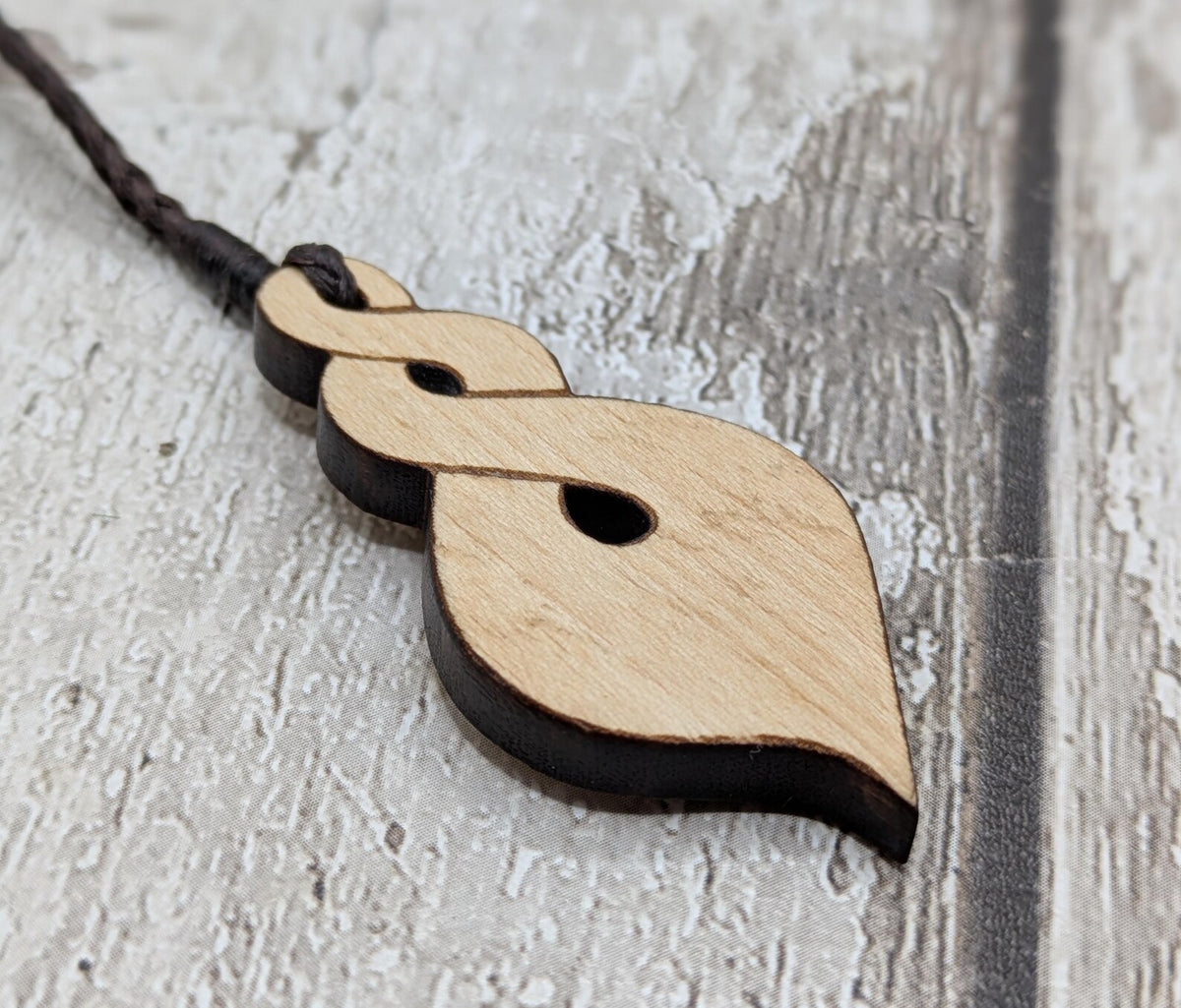 Lime wood, laser printed and cut pikorua pendant.