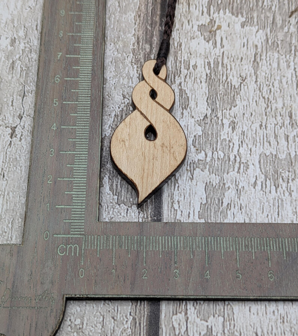 Lime wood, laser printed and cut pikorua pendant.