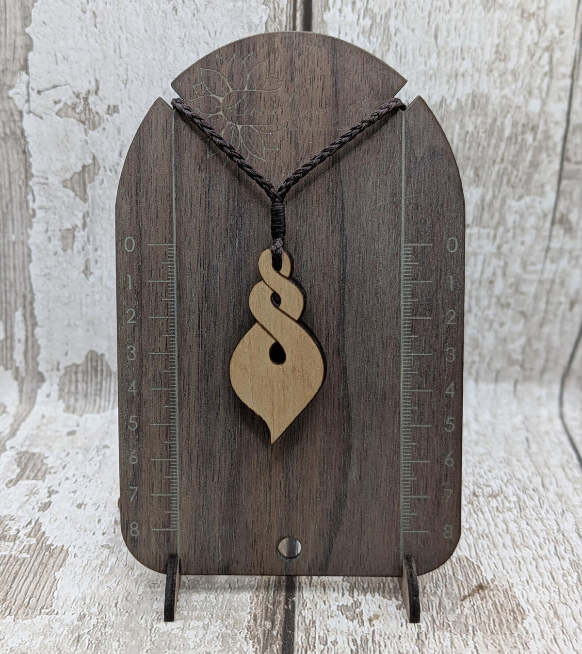 Lime wood, laser printed and cut pikorua pendant.