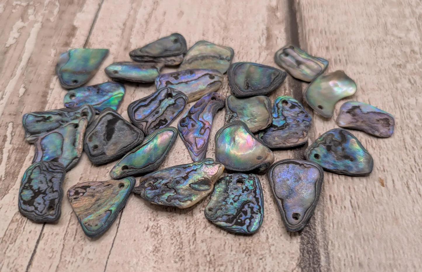 20 New Zealand wild rainbow Pāua satin finish abalone beads.