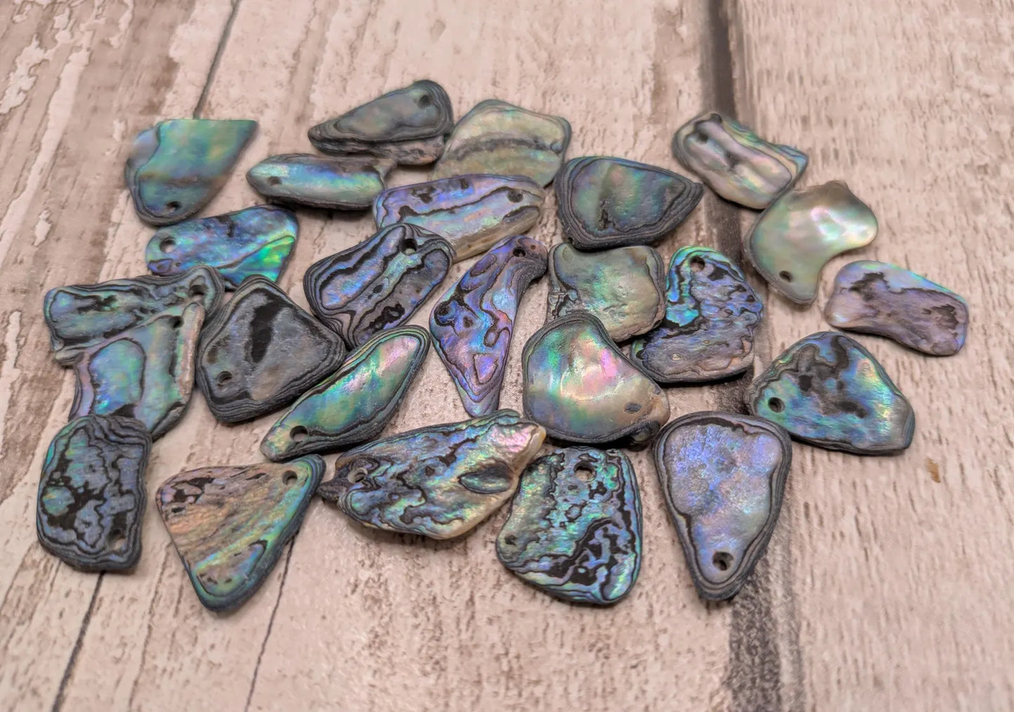 20 New Zealand wild rainbow Pāua satin finish abalone beads.