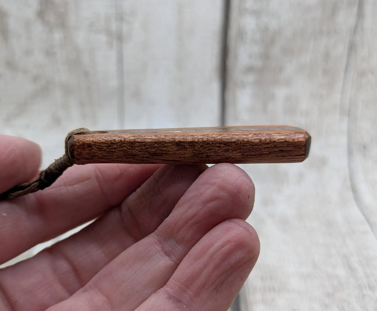 Sepele mahogany roimata and blue kyanite pendant.