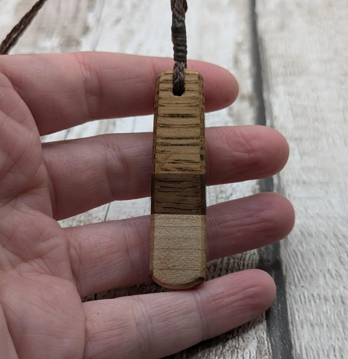 mixed wood roimata teardrop pendant.