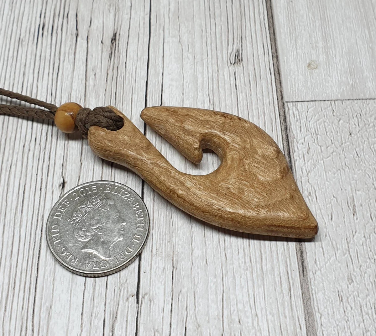 Ash wood hei matau fish hook pendant.